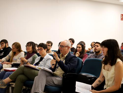 Jose Antonio Plaza with the microphone as a member of the jury in the first row of the Young Researchers Day 2025