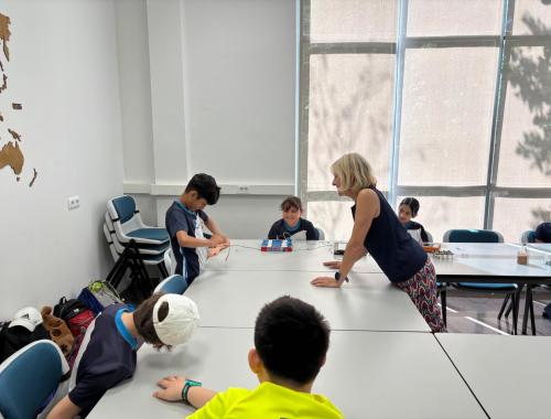 científica enseñando como funciona la electricidad a alumnado de primaria