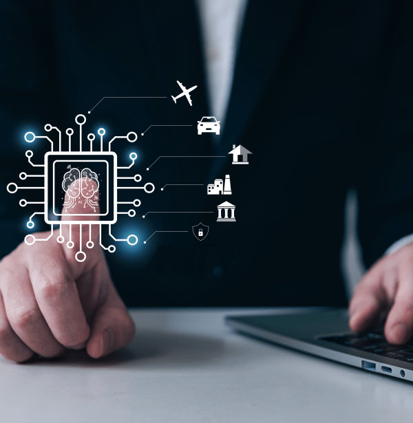Persona con traje y ordenador toca icono de chip y despliega múltiples aplicaciones. iStock